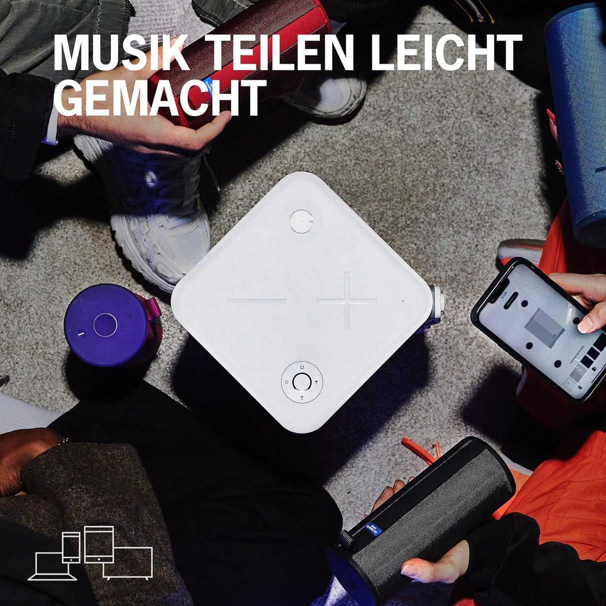 Mehrere Bluetooth-Lautsprecher und Smartphone beim gemeinsamen Musikstreaming und Teilen von Musik